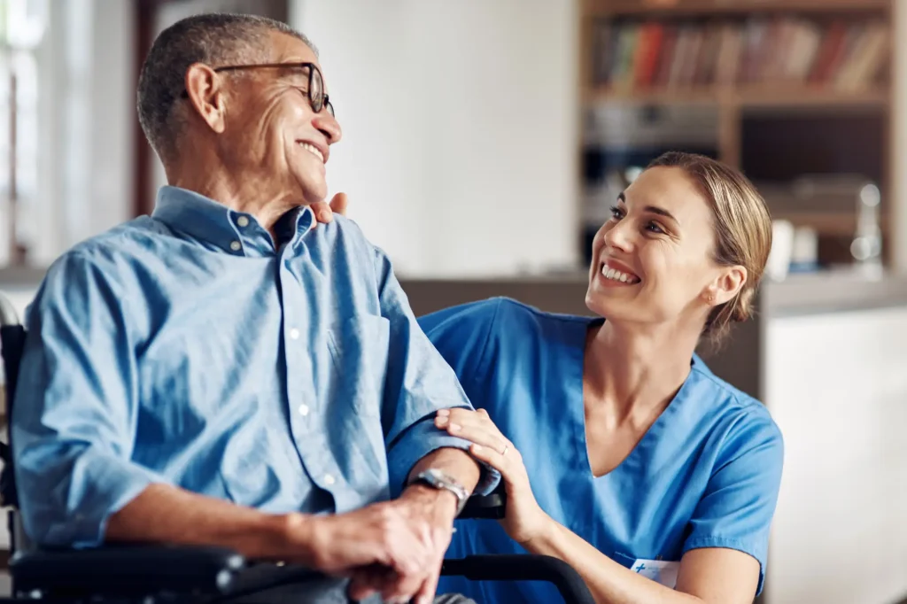 senior man in a wheelchair being cared for by a professional nurse