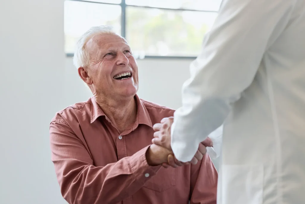 senior man looking up at caregiver