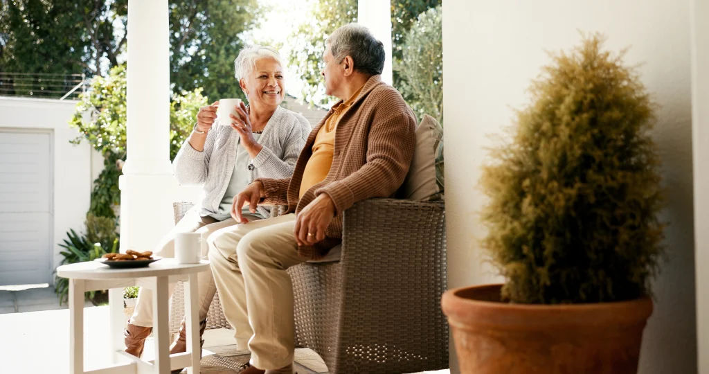senior couple sitting outside on porch