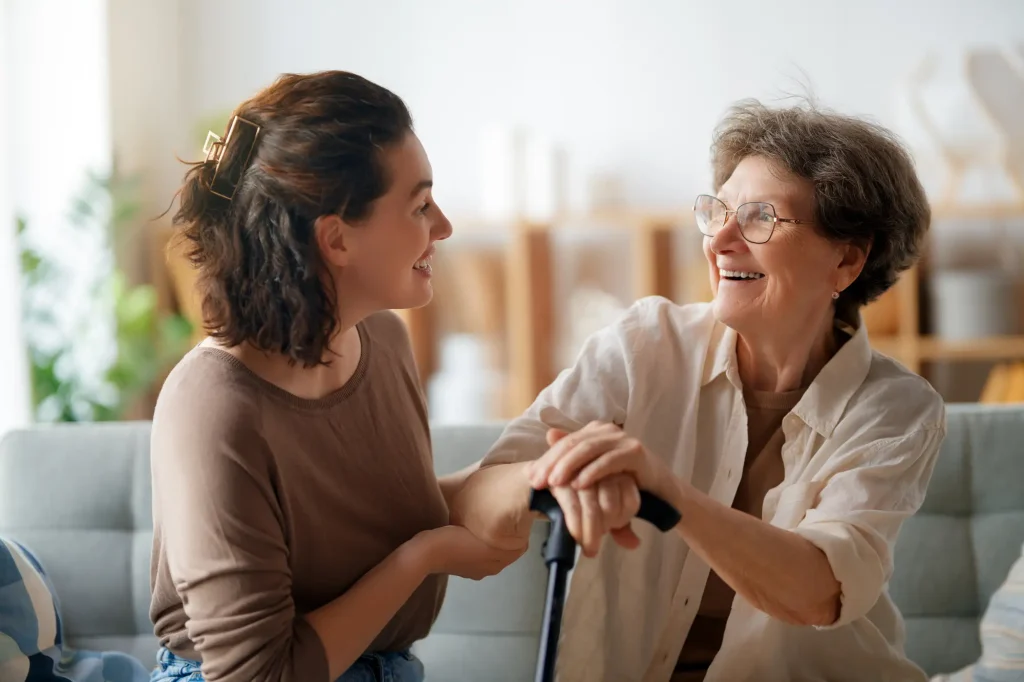 senior woman and younger woman sitting together 