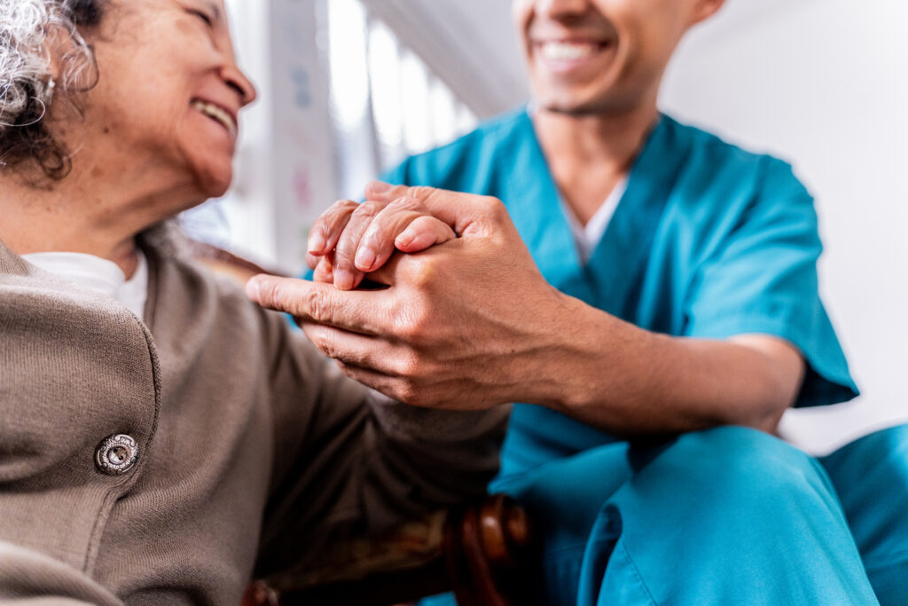 Male caregiver helping senior woman
