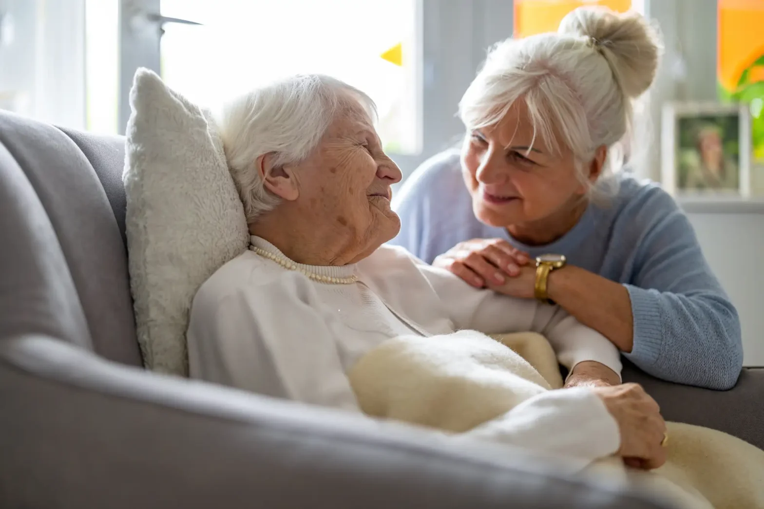 Elderly woman with her caregiver in hospice care.
