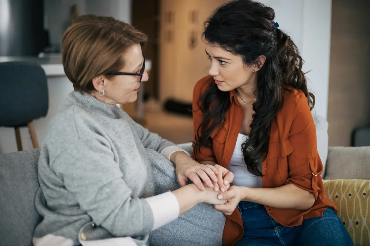 woman holding hands of older woman
